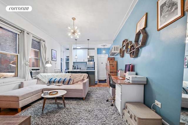 living area with a notable chandelier, visible vents, light wood-style flooring, ornamental molding, and cooling unit