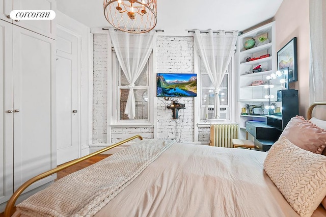 bedroom featuring radiator, visible vents, a chandelier, and cooling unit