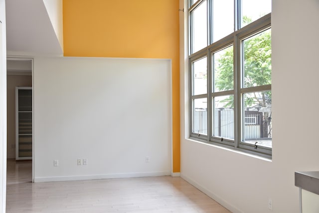 unfurnished room featuring baseboards and wood finished floors