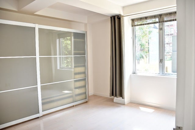 doorway to outside with baseboards and wood finished floors