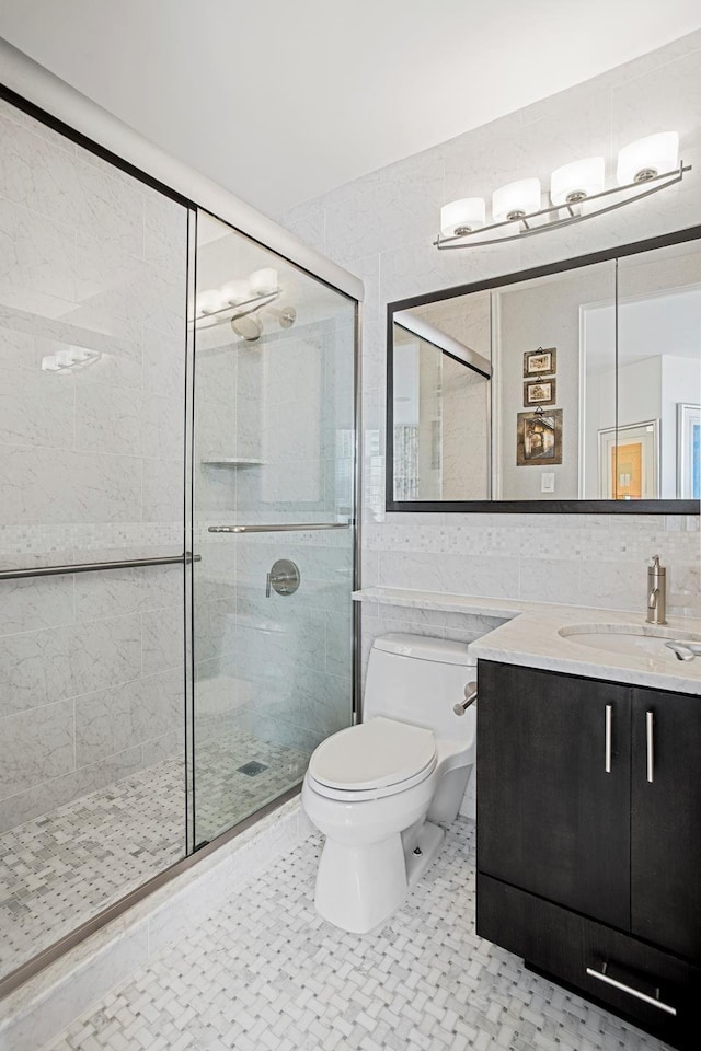 bathroom featuring toilet, a shower stall, backsplash, and tile walls