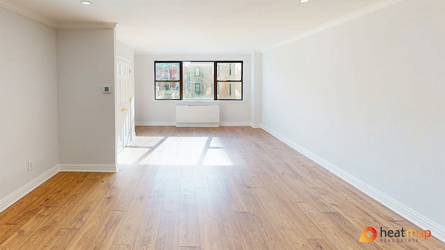 empty room featuring light wood finished floors, baseboards, crown molding, and recessed lighting