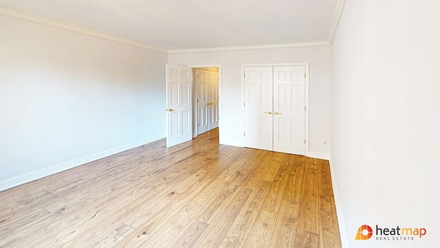 unfurnished bedroom featuring ornamental molding, light wood-type flooring, and baseboards