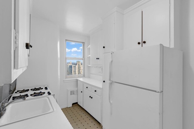 spare room featuring baseboards, a healthy amount of sunlight, and radiator heating unit