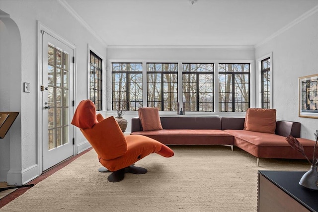 sunroom / solarium featuring arched walkways and a healthy amount of sunlight