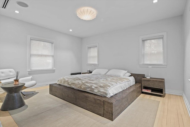 bedroom with visible vents, recessed lighting, hardwood / wood-style flooring, and baseboards