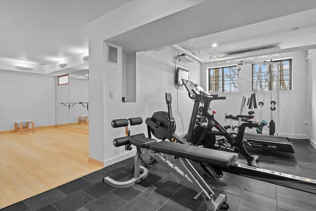 workout room with dark wood-style floors and baseboards