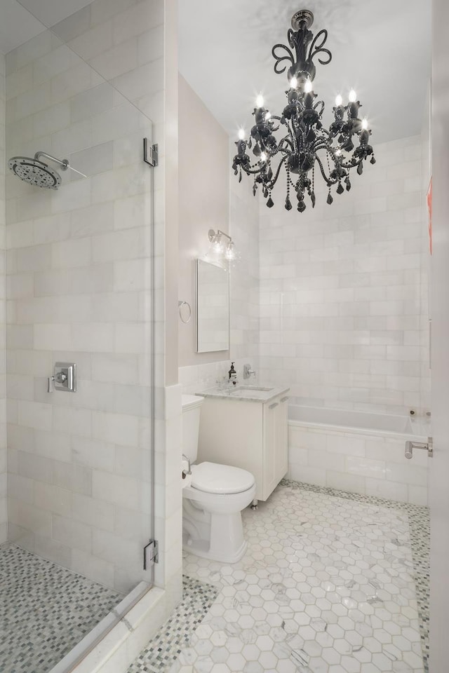 full bath featuring toilet, a notable chandelier, vanity, tile patterned floors, and a stall shower