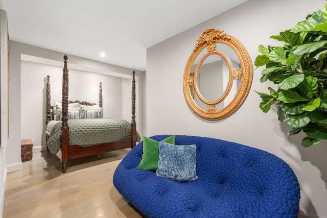 bedroom with baseboards and wood finished floors