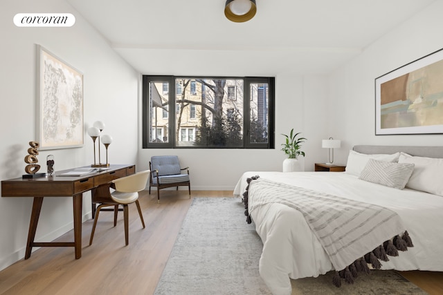 bedroom with baseboards, visible vents, and light wood-type flooring