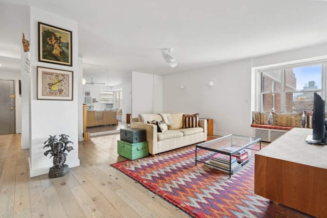 living area featuring light wood finished floors and baseboards