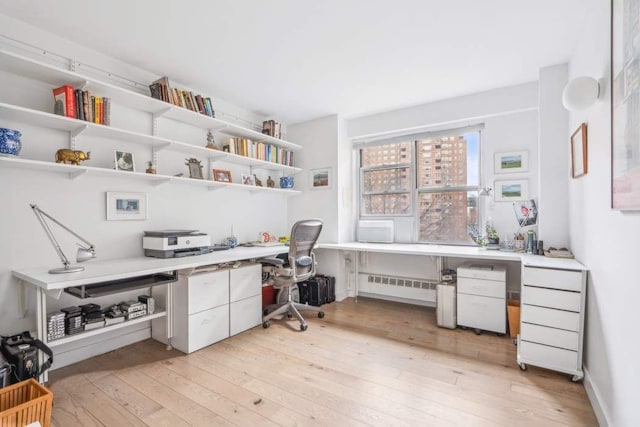 office area featuring built in study area and light wood-style flooring