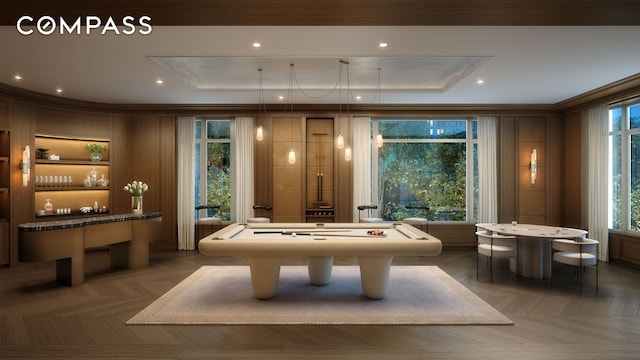 rec room with billiards, a tray ceiling, and crown molding