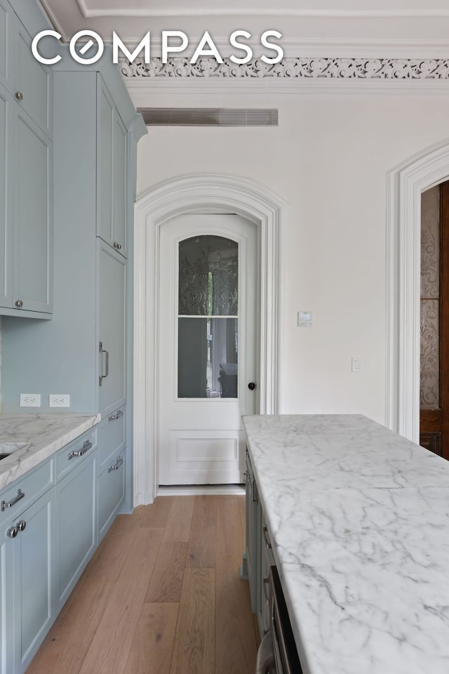 kitchen featuring light stone counters and hardwood / wood-style floors