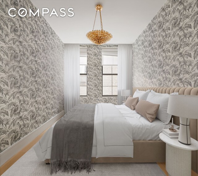 bedroom with wallpapered walls, wood finished floors, and baseboards