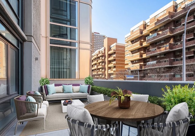 balcony featuring an outdoor hangout area and a view of city