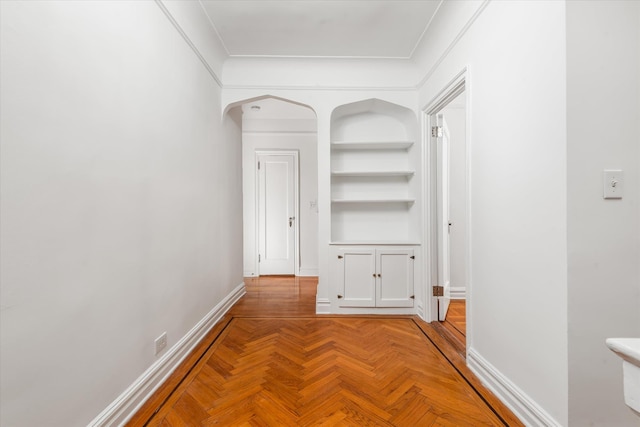 680 W 204th St Unit 3-F, New York City, NY 10034 - hall featuring built in shelves, baseboards, arched walkways, and crown molding