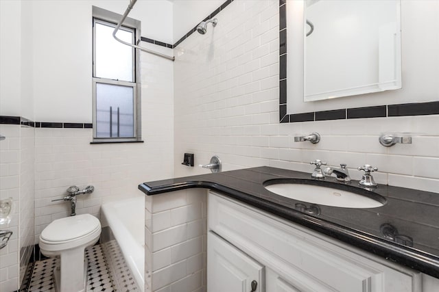 bathroom featuring toilet, tile walls, vanity, and tile patterned floors