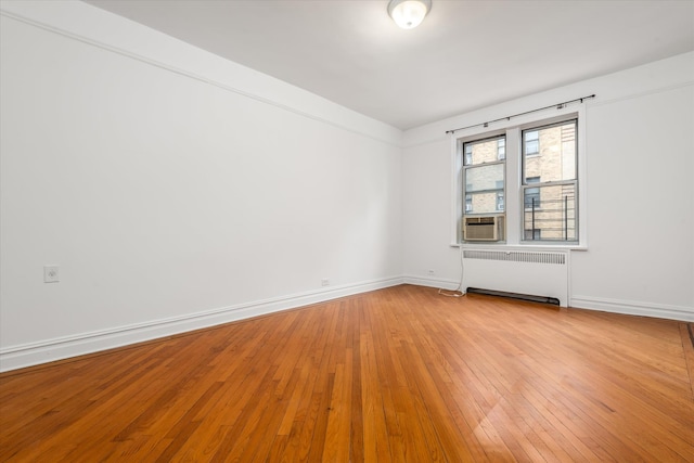 680 W 204th St Unit 3-F, New York City, NY 10034 - unfurnished room with radiator, light wood finished floors, and cooling unit