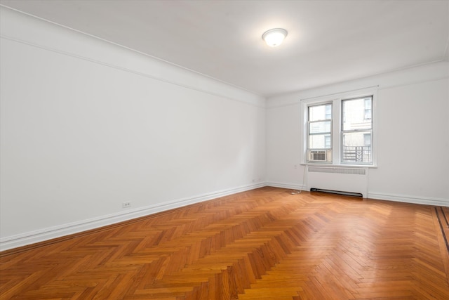 empty room with radiator and baseboards