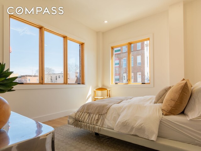 bedroom featuring recessed lighting, baseboards, and wood finished floors