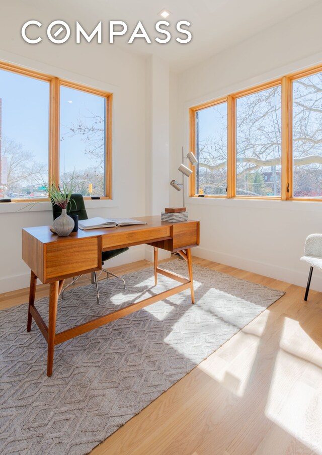 office space featuring recessed lighting, wood finished floors, and baseboards