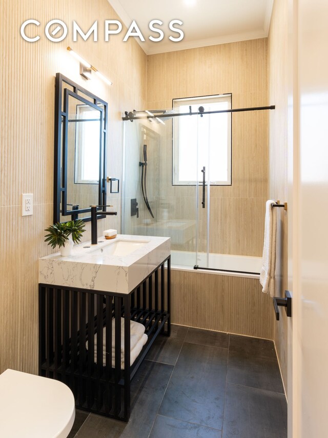 bathroom with enclosed tub / shower combo, vanity, tile patterned flooring, and a wealth of natural light