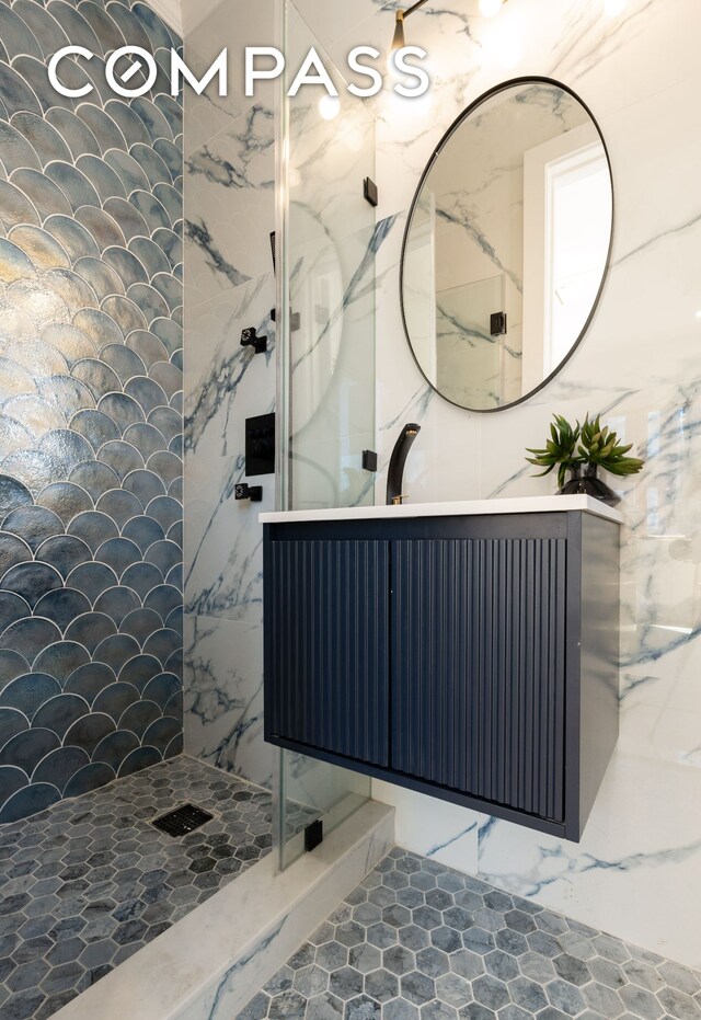 bathroom with a walk in shower and vanity