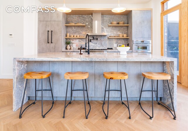 kitchen featuring open shelves, tasteful backsplash, ventilation hood, and white oven