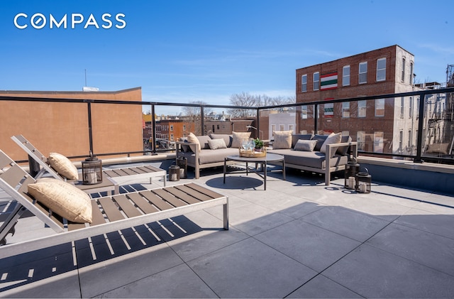 view of patio with outdoor lounge area and a balcony