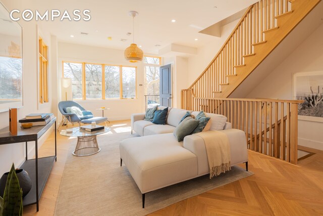 living area featuring baseboards and recessed lighting