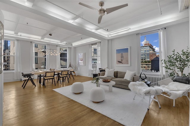 living room with a ceiling fan and wood finished floors