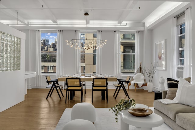 living room with beam ceiling, a notable chandelier, and wood finished floors