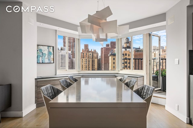 301 E 78th St Unit 16Ef, New York City, NY 10075 - dining area with a skyline view and light wood-style flooring