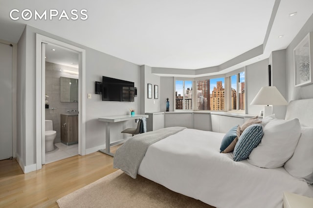 301 E 78th St Unit 16Ef, New York City, NY 10075 - bedroom featuring light wood-style flooring, ensuite bath, recessed lighting, and baseboards