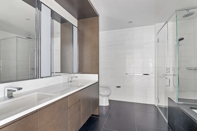 full bath featuring a shower stall, tile walls, a sink, and tile patterned floors