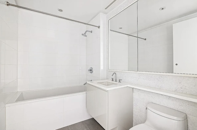 bathroom with toilet, washtub / shower combination, and vanity