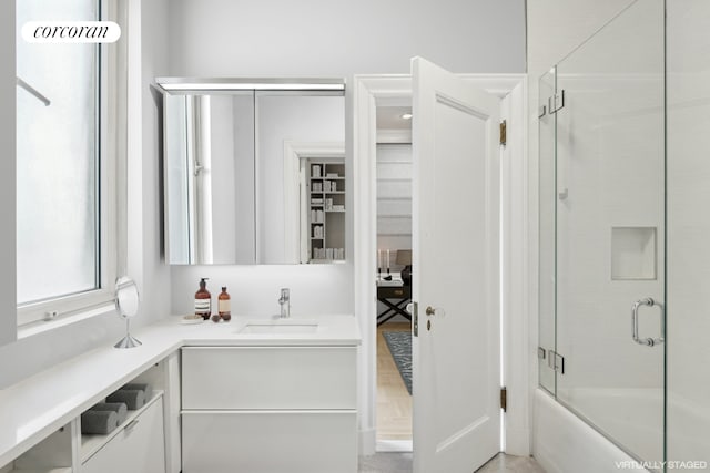 full bath featuring combined bath / shower with glass door and vanity