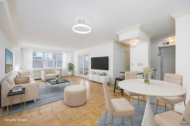 living room featuring visible vents and ornamental molding