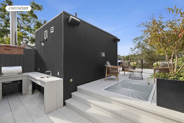 view of patio / terrace featuring exterior kitchen and fence