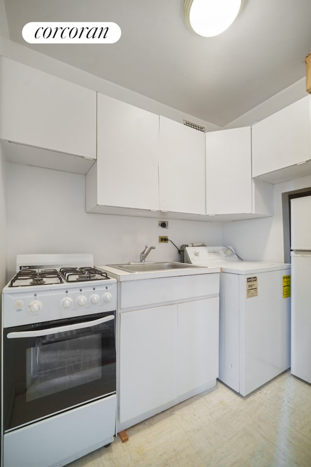 kitchen featuring a sink, washer / clothes dryer, white appliances, white cabinets, and light countertops