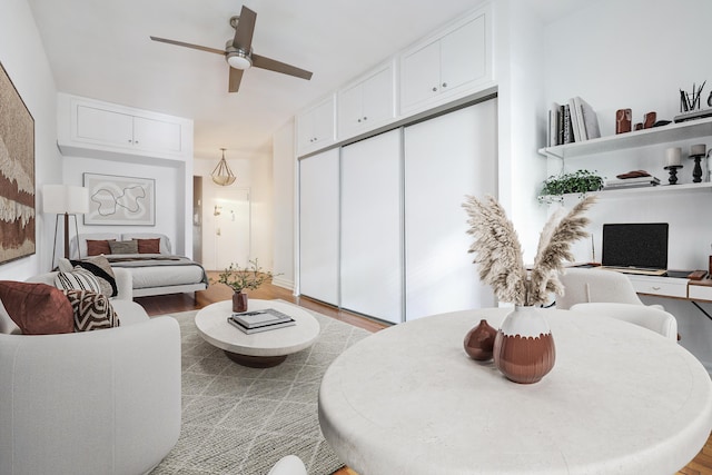 living area featuring ceiling fan and wood finished floors