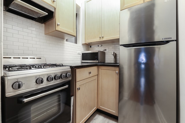 kitchen featuring tasteful backsplash, exhaust hood, dark countertops, and stainless steel appliances