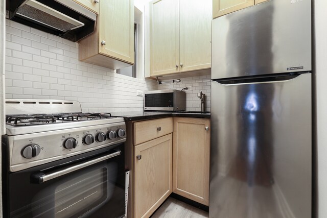 205 E 89th St Unit D2, New York City, NY 10128 - kitchen featuring stainless steel appliances, extractor fan, light brown cabinets, and decorative backsplash