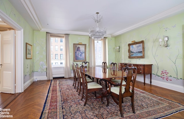 dining room with baseboards, ornamental molding, and a notable chandelier