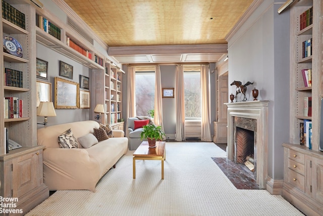 living room featuring carpet floors, ornamental molding, a high end fireplace, and baseboards