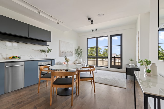 dining space featuring dark wood finished floors and track lighting