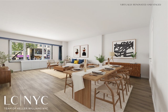 dining area with baseboards and wood finished floors