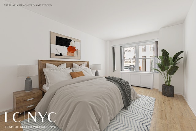 bedroom featuring light wood-style floors and baseboards