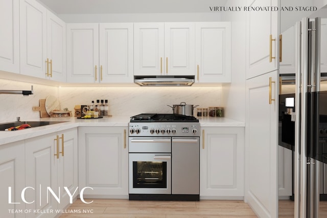 kitchen with light countertops, light wood-style flooring, white cabinets, and double oven range